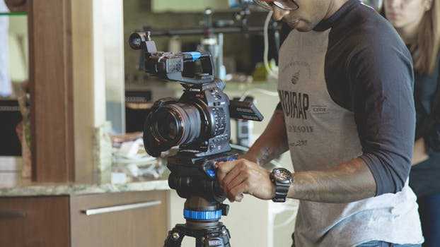 man with a video camera filming