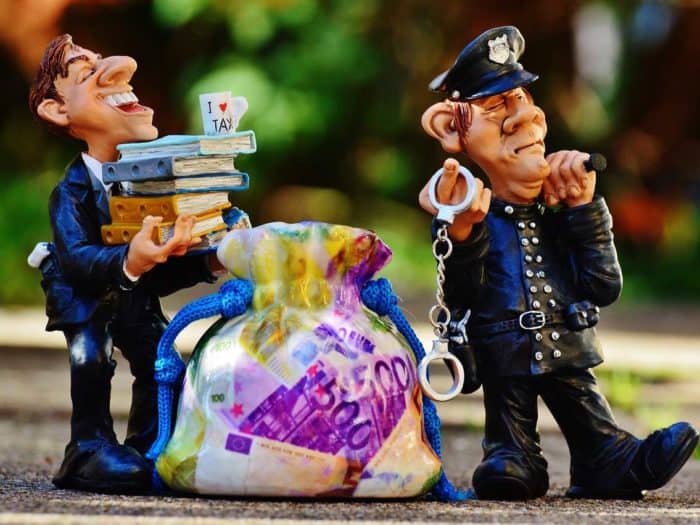taxes tax evasion police handcuffs